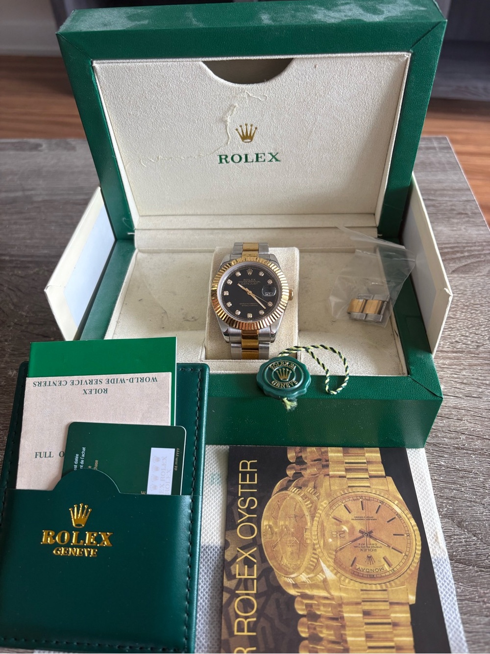 Rolex two-tone gold and black dial watch with green box